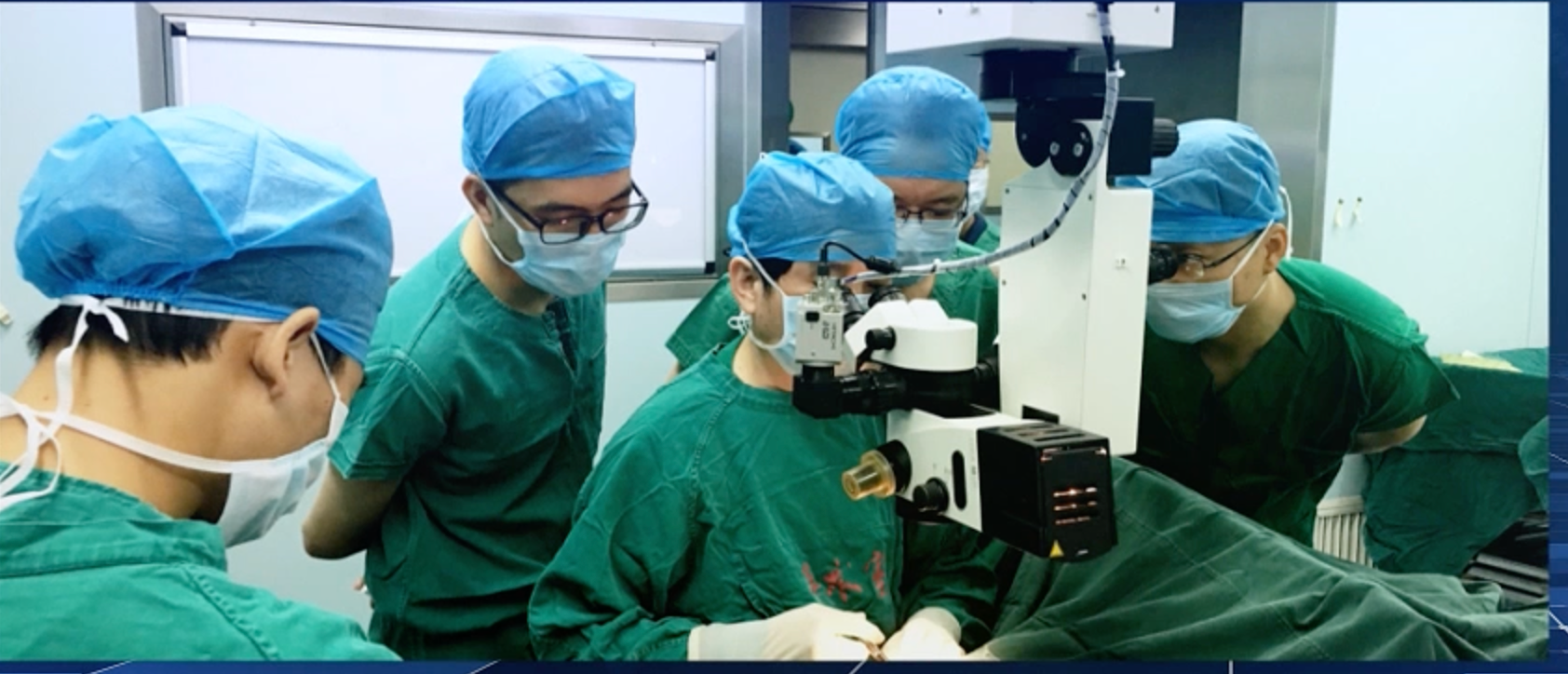 Ophthalmic surgical team collaborating around a microscope in a clinical training setting